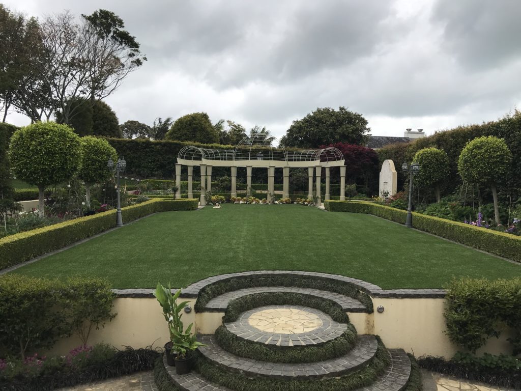 Maintenance team mowing and edging a lawn
