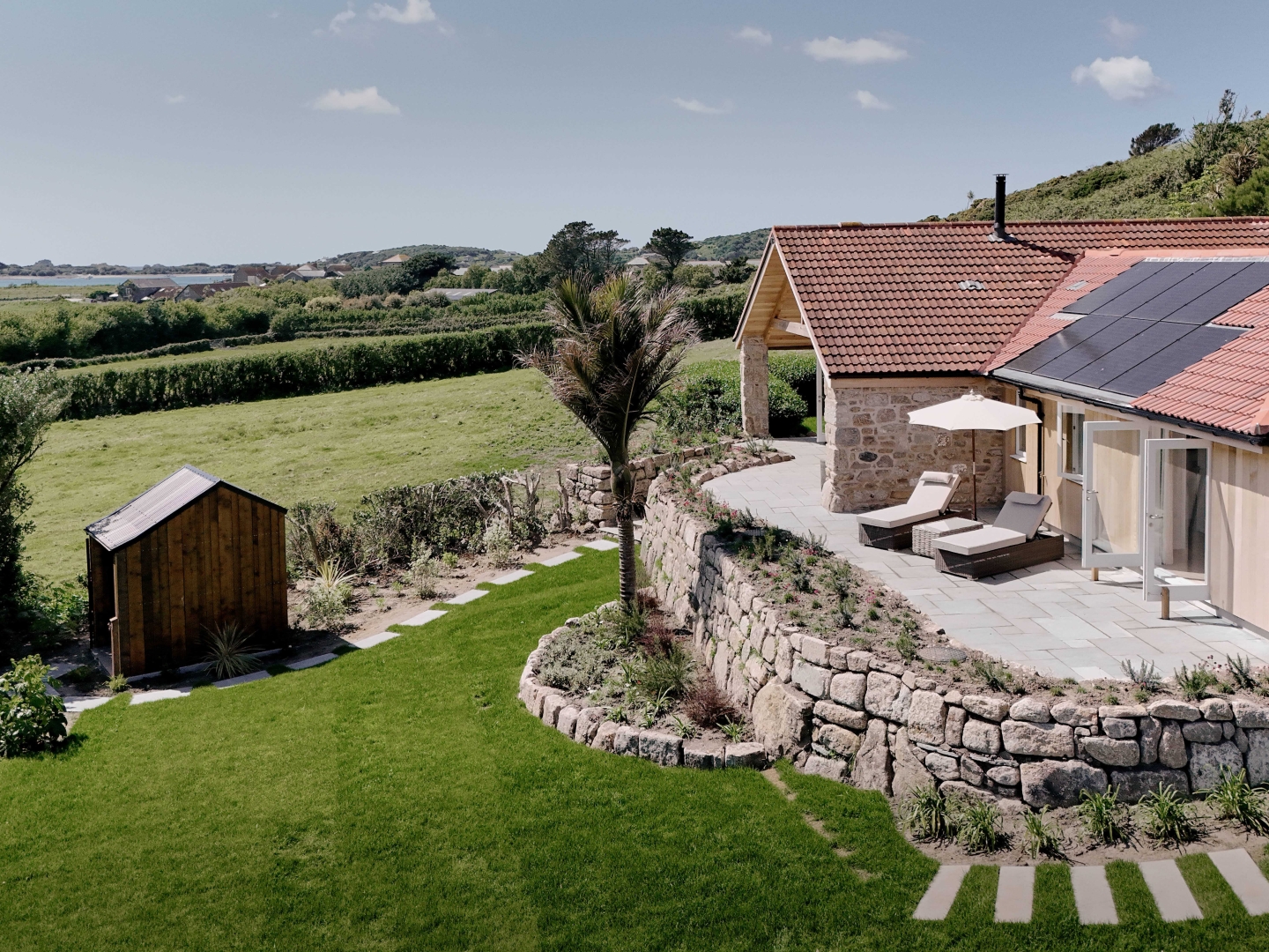 Elevated patio with retaining stonework and planting