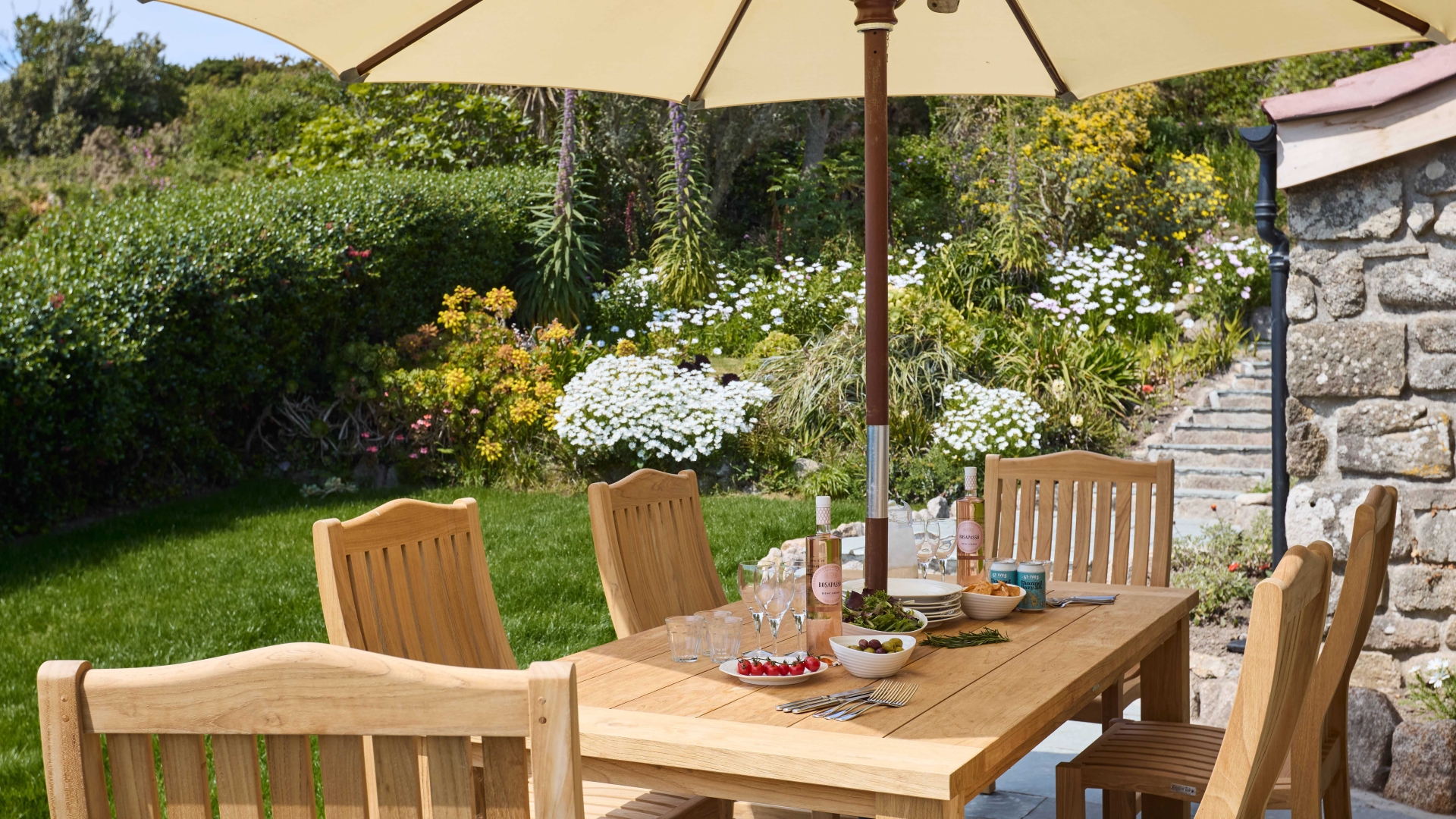 Garden path across lawn towards a timber shed